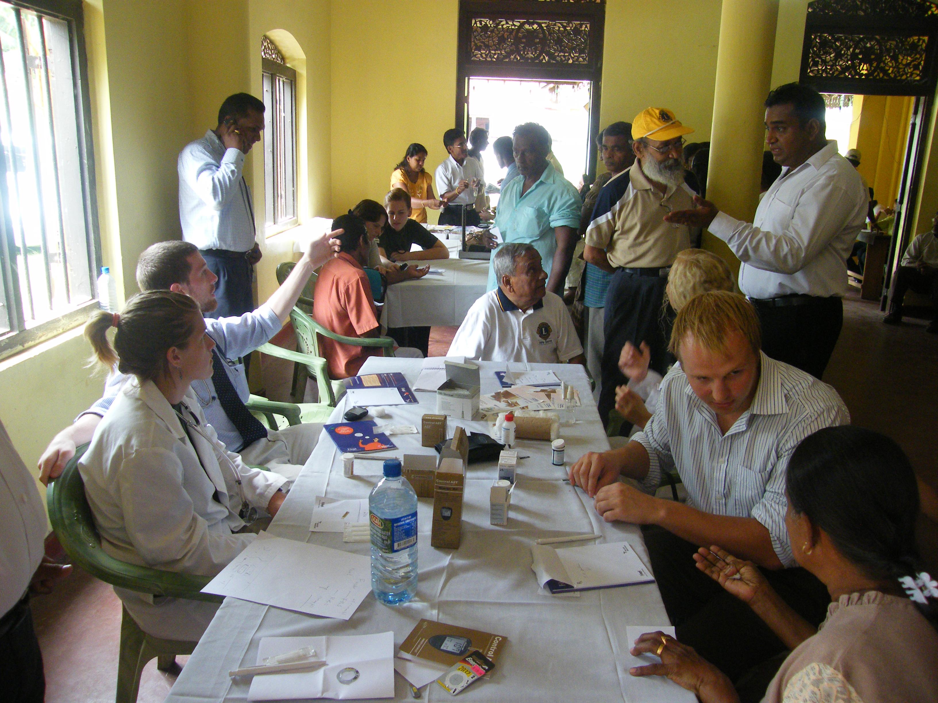 A group of doctors and Projects Abroad interns go over their notes at the hospital during their pharmacy internship in Sri Lanka. Projects Abroad interns and local doctors going over their notes at the hospital during their pharmacy internship in Sri Lanka.
